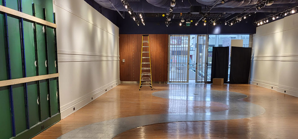 Restaurant construction space featuring green wall panels, wooden accents, a ladder, and modern lighting, illustrating innovative design elements for 2025 renovations.
