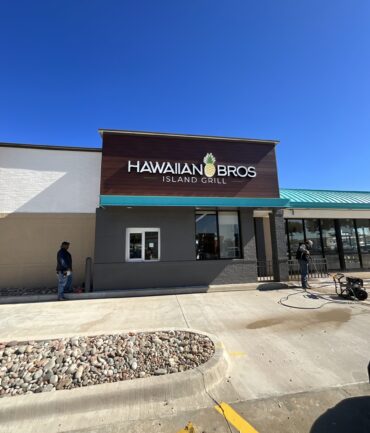 Hawaiian Bros Island Grill storefront featuring a modern design, clear signage, and a well-maintained exterior, showcasing Kinetic Builders Corp's commercial construction expertise in restaurant build-outs.