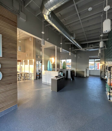 Interior view of a commercial construction project by Kinetic Builders Corp, showcasing modern design elements, open space, and a reception area with sleek finishes, highlighting craftsmanship in restaurant build-outs.