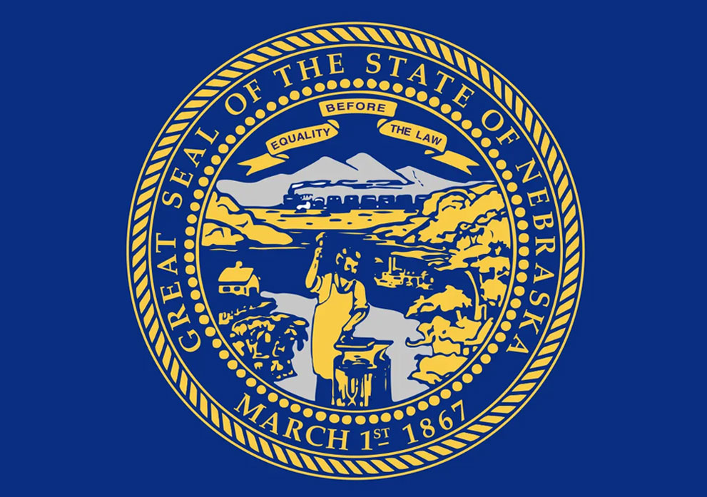 Great Seal of the State of Nebraska featuring a central figure with tools, symbolizing industry and agriculture, surrounded by the state motto "Equality Before the Law" and elements representing Nebraska's landscape and economy, set against a blue background.