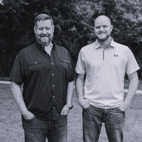 Aaron Knapp and Joe Ellis, founders of Kinetic Builders Corp., standing together outdoors, showcasing their partnership in commercial construction.