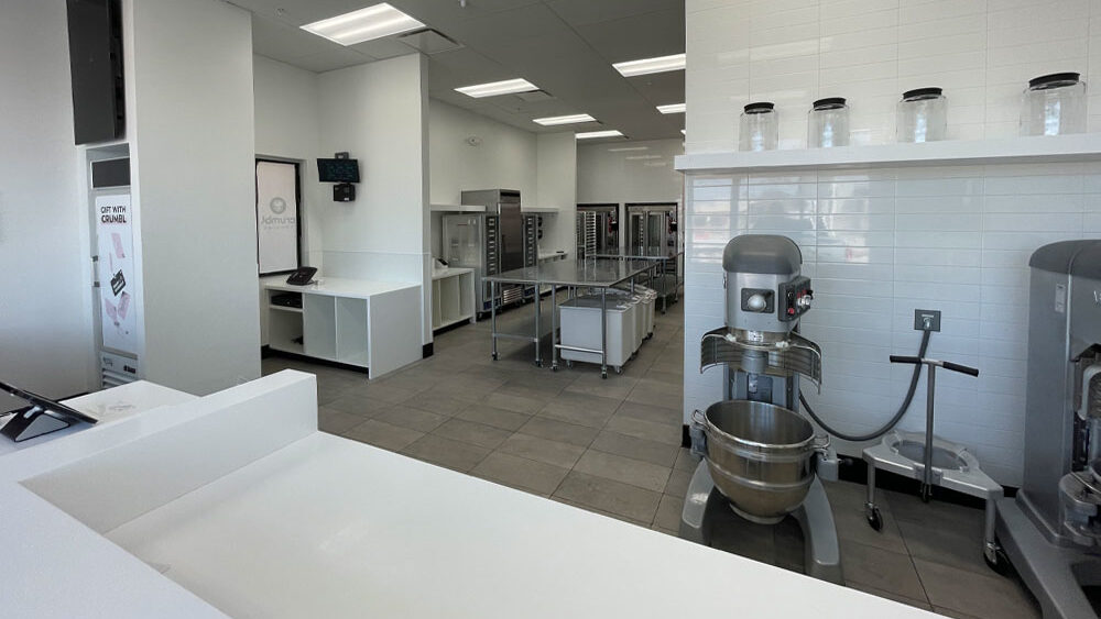 Modern restaurant kitchen layout featuring stainless steel equipment, prep areas, and storage solutions, emphasizing compliance with health and safety regulations.